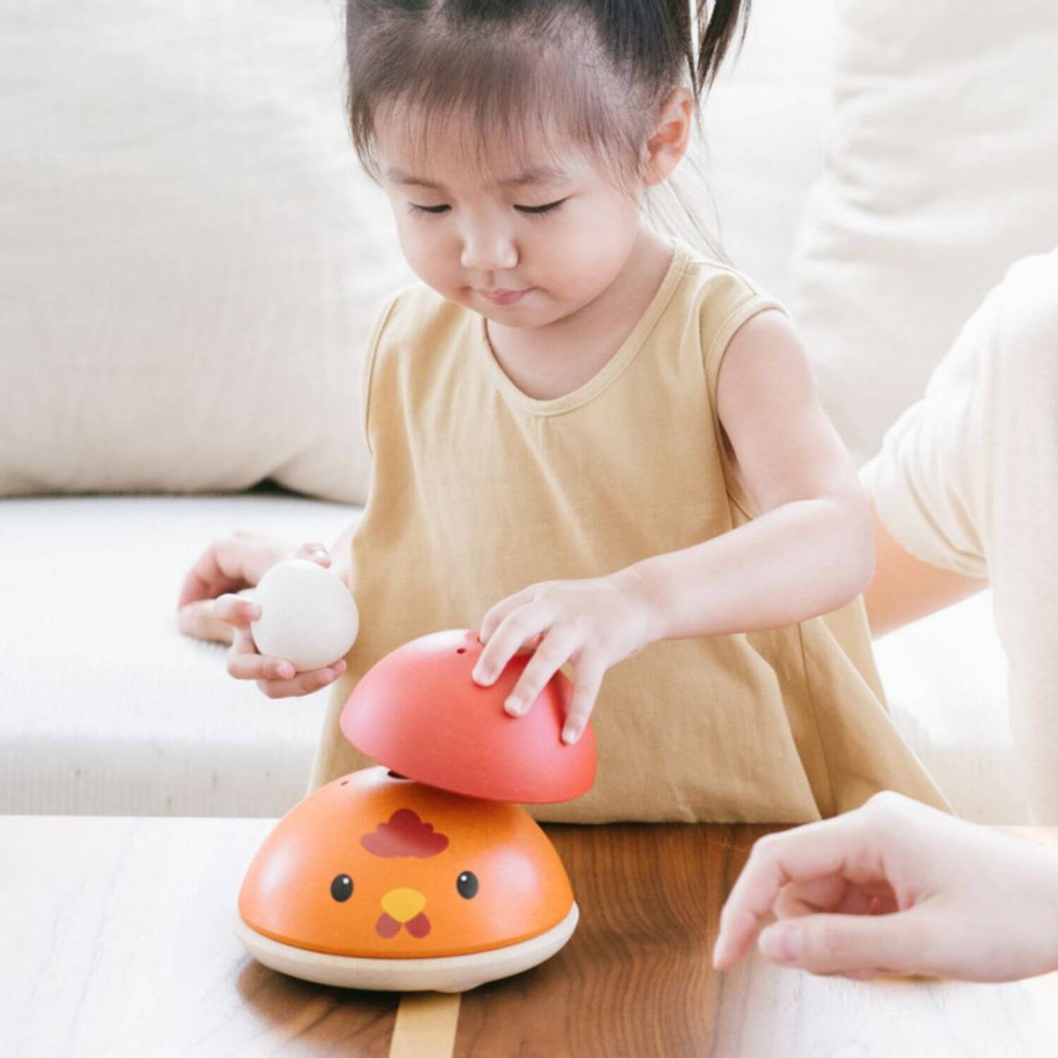 Girl Playing PlanToys Chicken Nesting