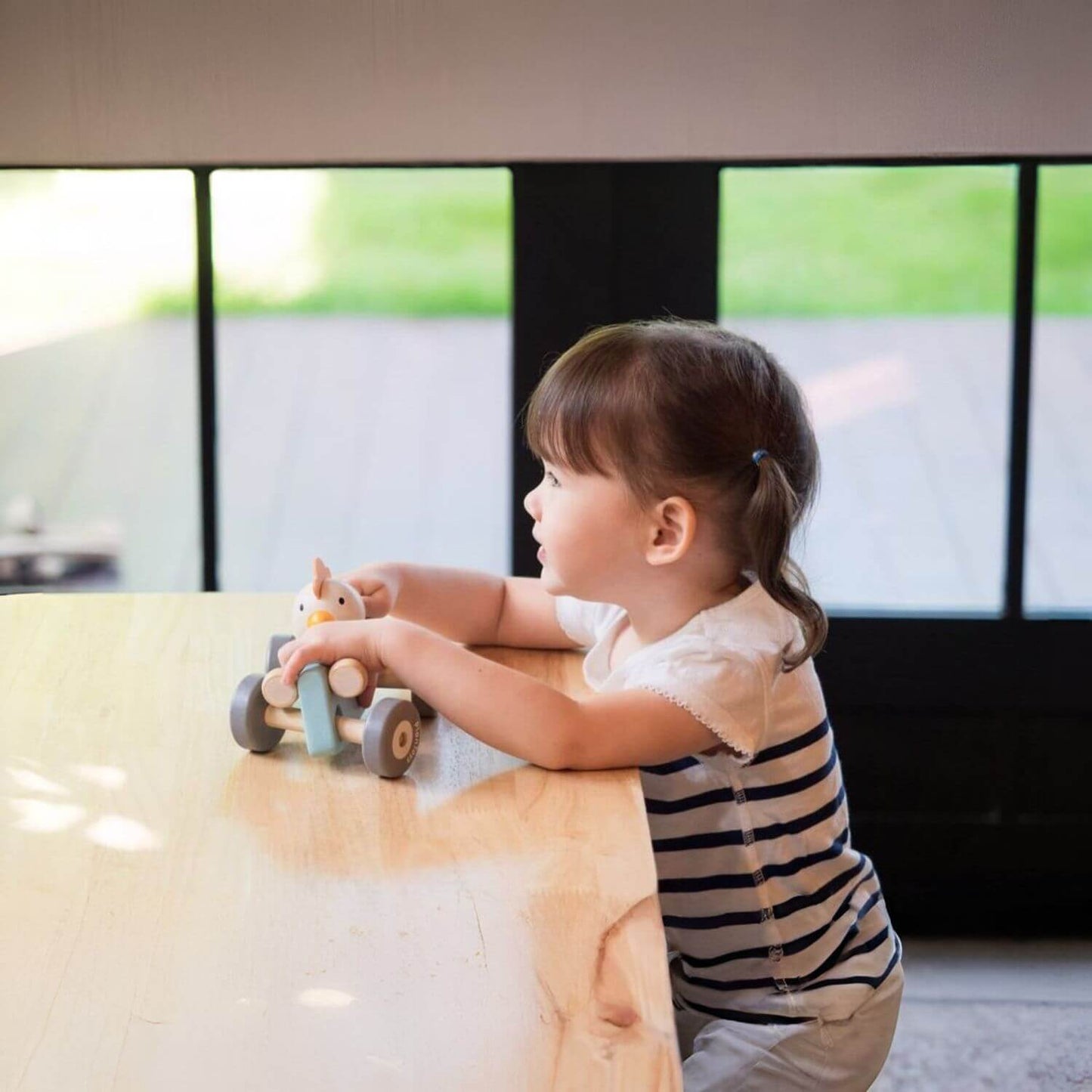 Girl Playing PlanToys Chicken Racing Car