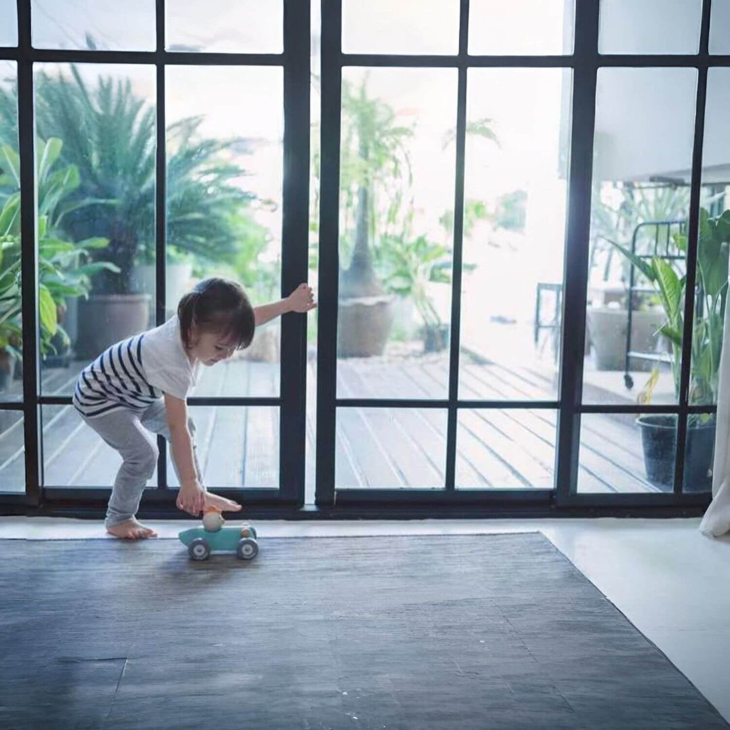 Girl Playing PlanToys Chicken Racing Car