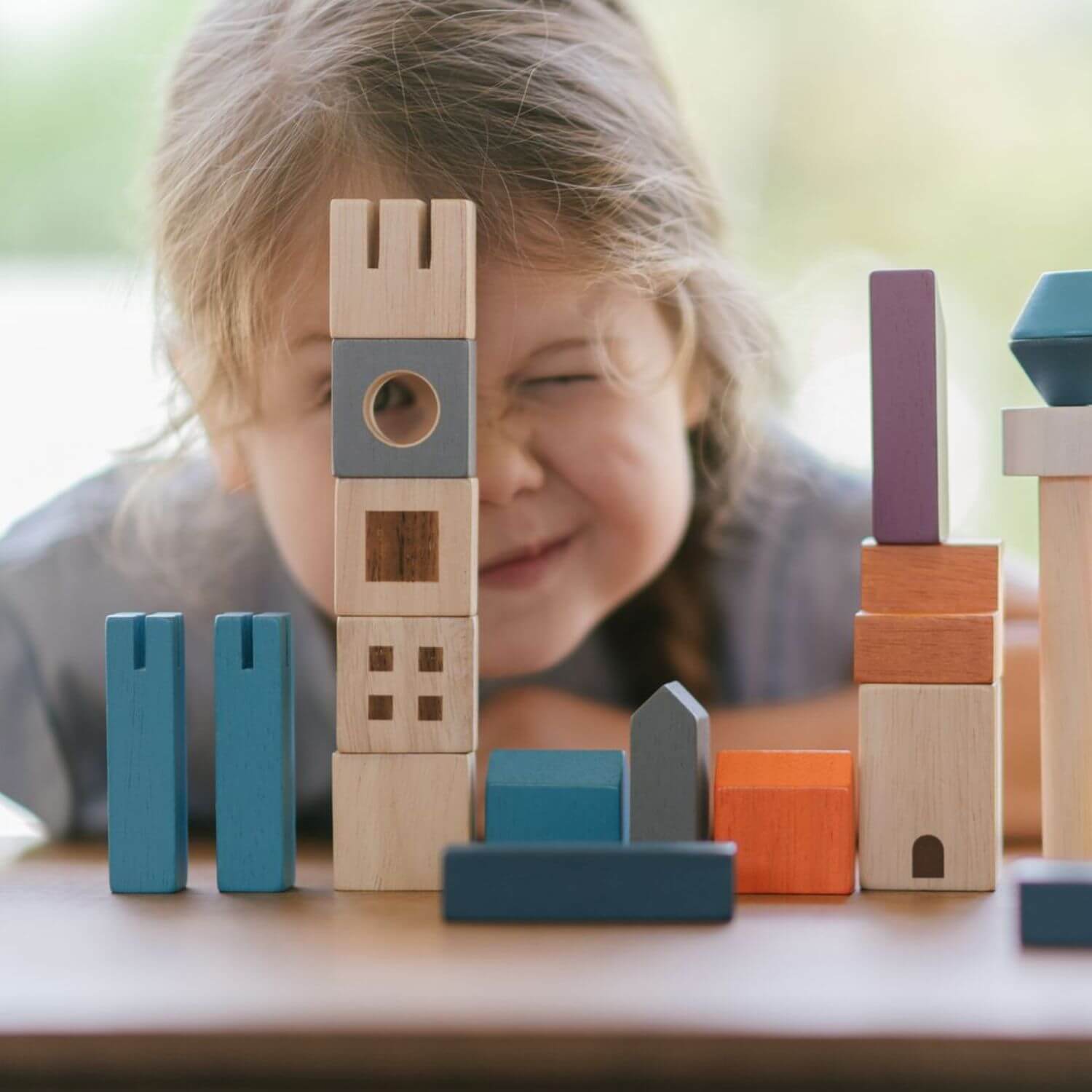 Girl Playing PlanToys Cityscape Blocks