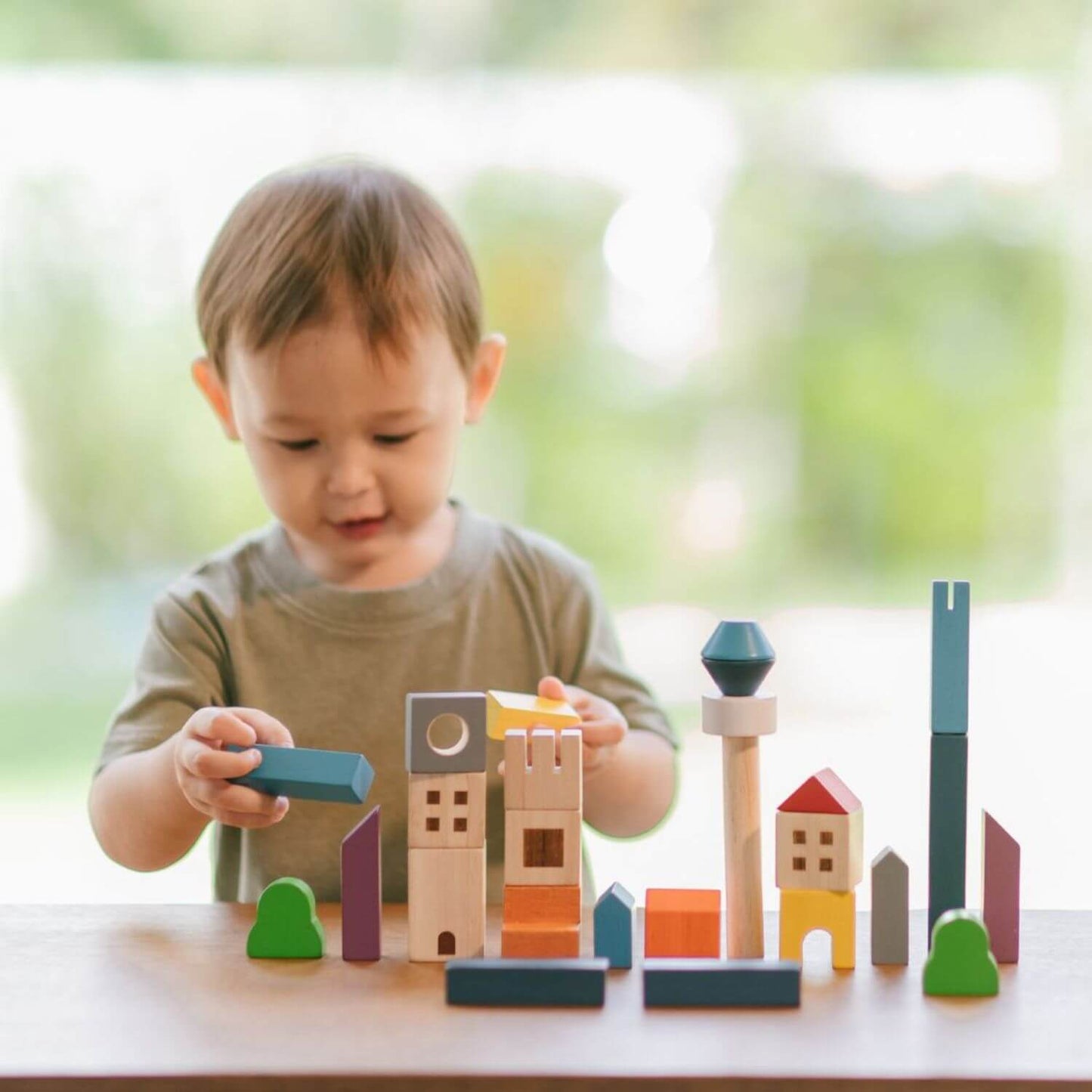 Boy Playing PlanToys Cityscape Blocks