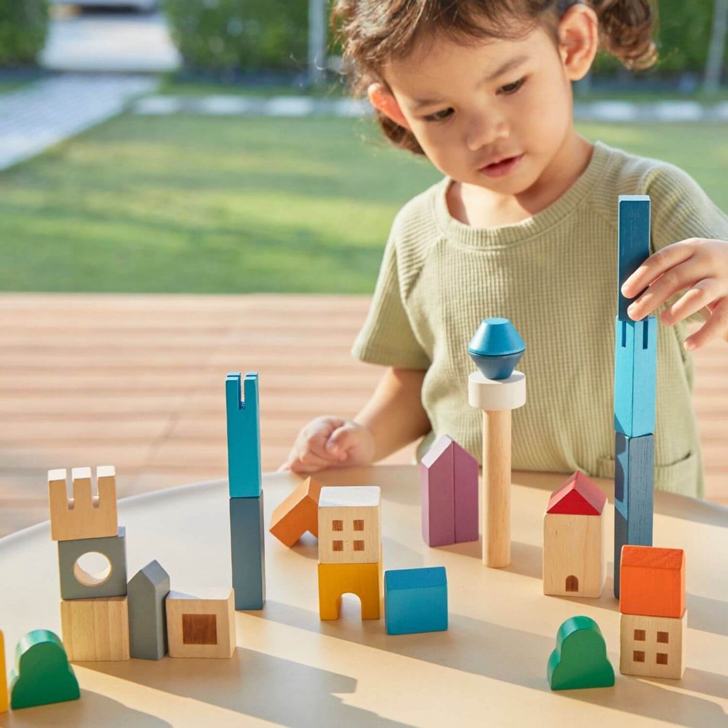 Girl Playing PlanToys Cityscape Blocks