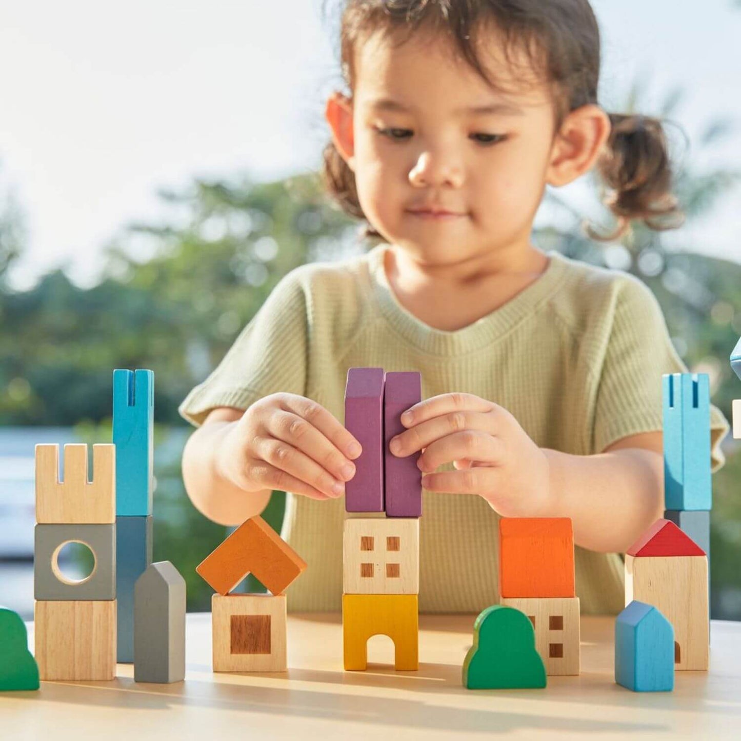 Girl Playing PlanToys Cityscape Blocks