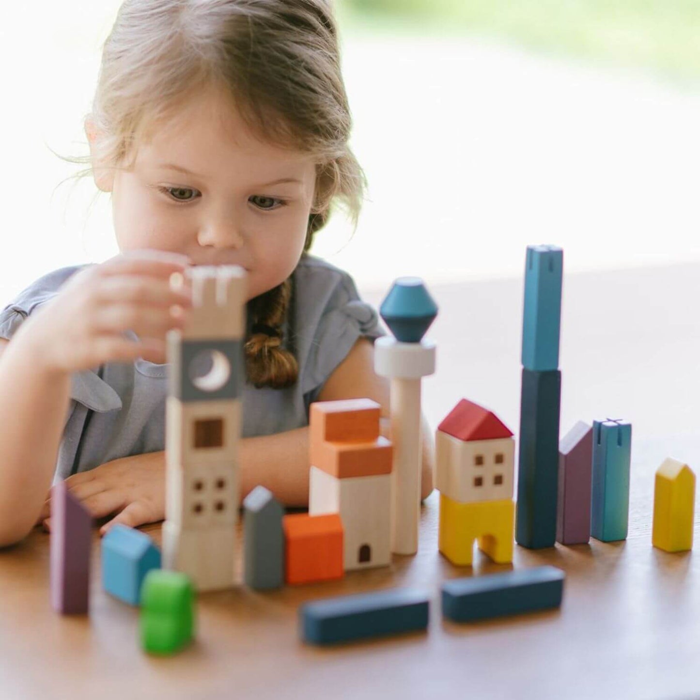 Girl Playing PlanToys Cityscape Blocks