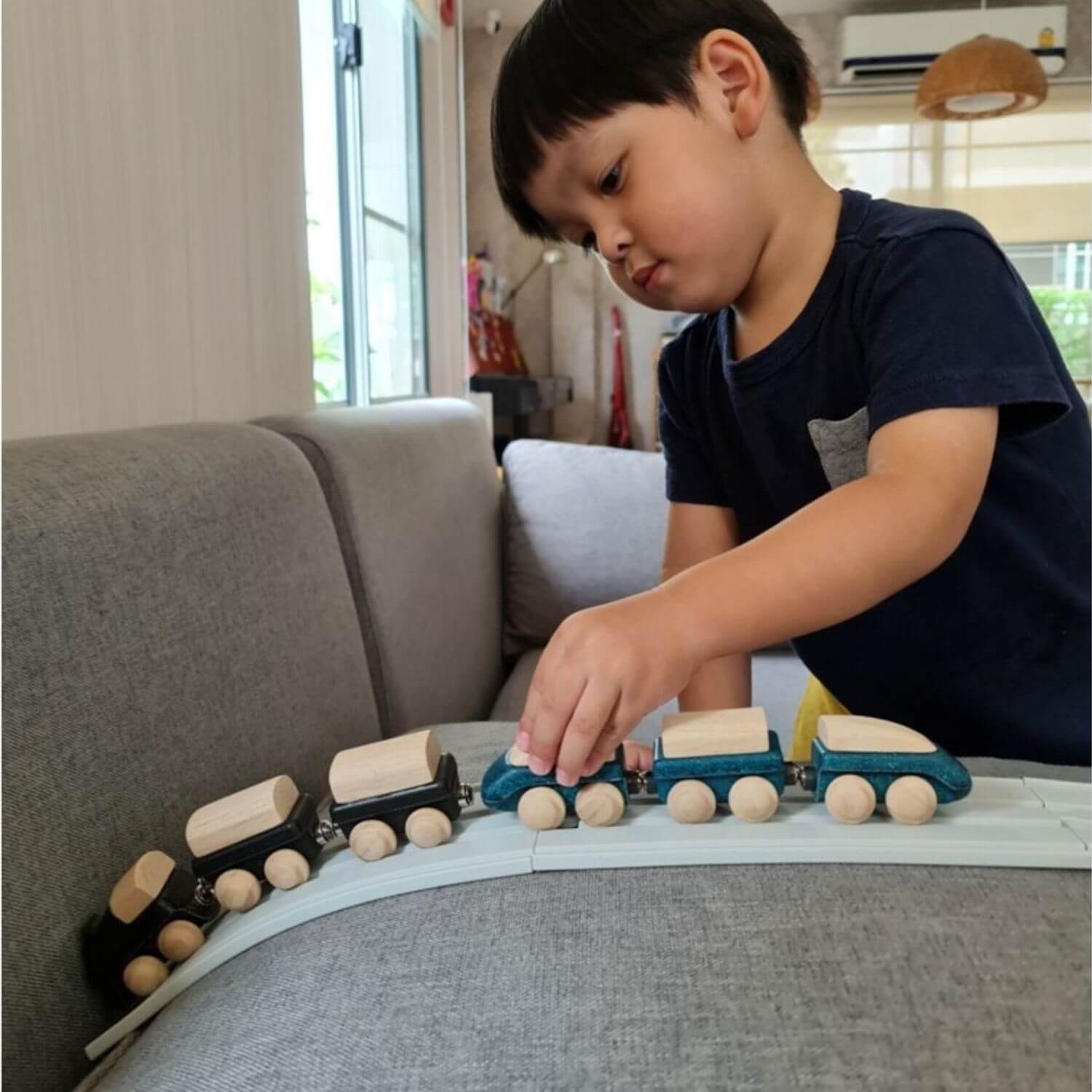 Boy Playing PlanToys Classic Train