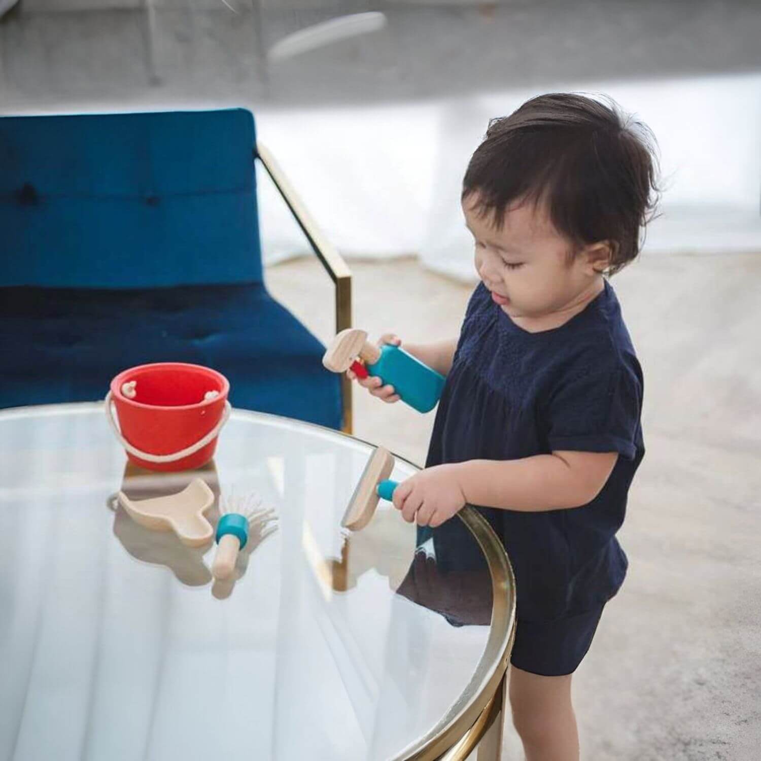 Boy Playing PlanToys Cleaning Set