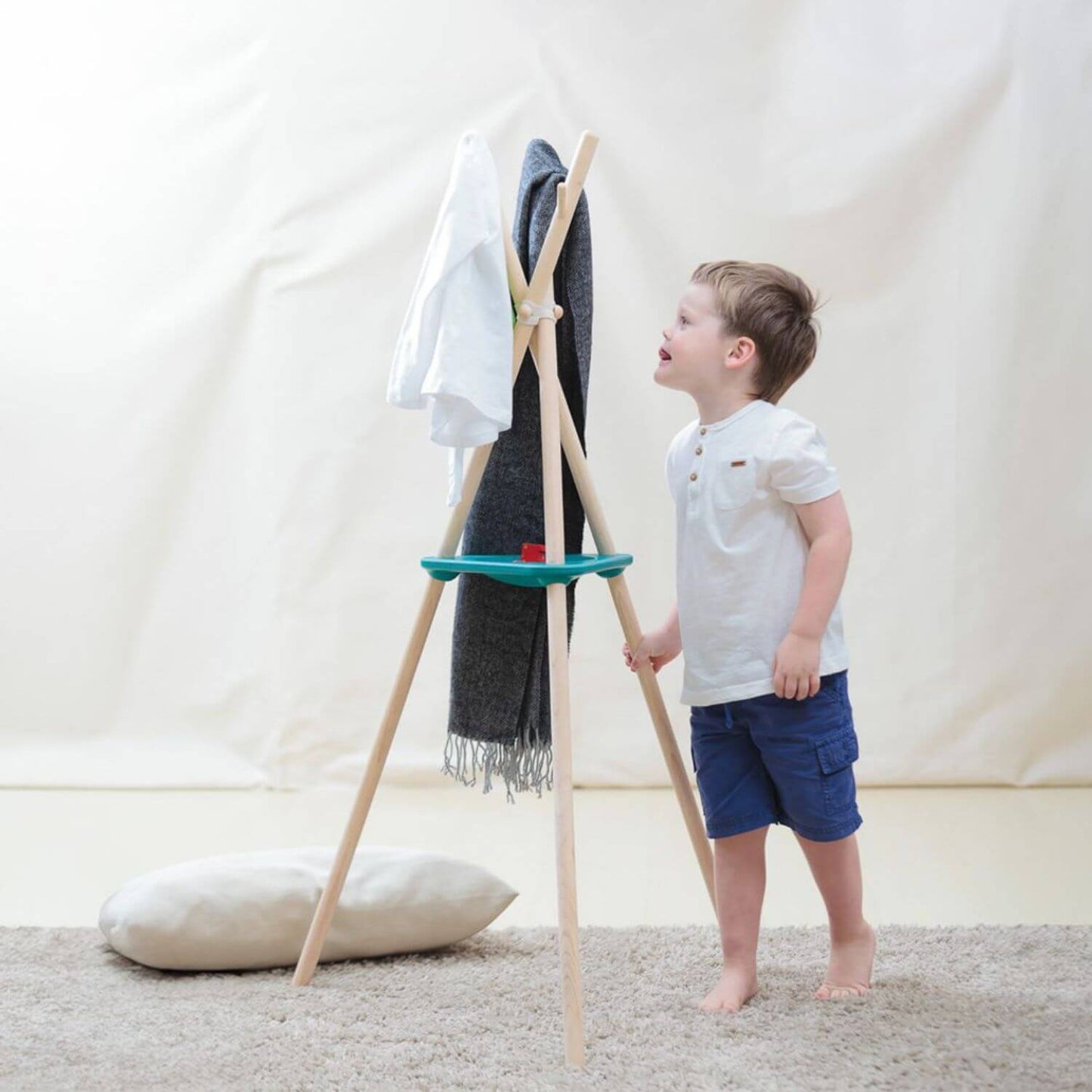 Boy Holding PlanToys Coat Rack