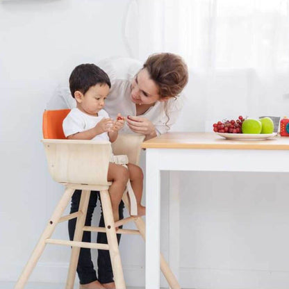 Woman and child sitting on PlanToys High Chair - Orange at a table with a plate of fruits