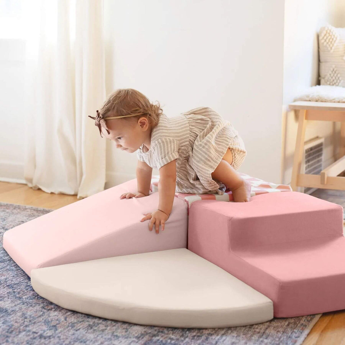 A toddler crawls on Tiny Land® PlayNest Climbing Blocks - Violet in a bright room.