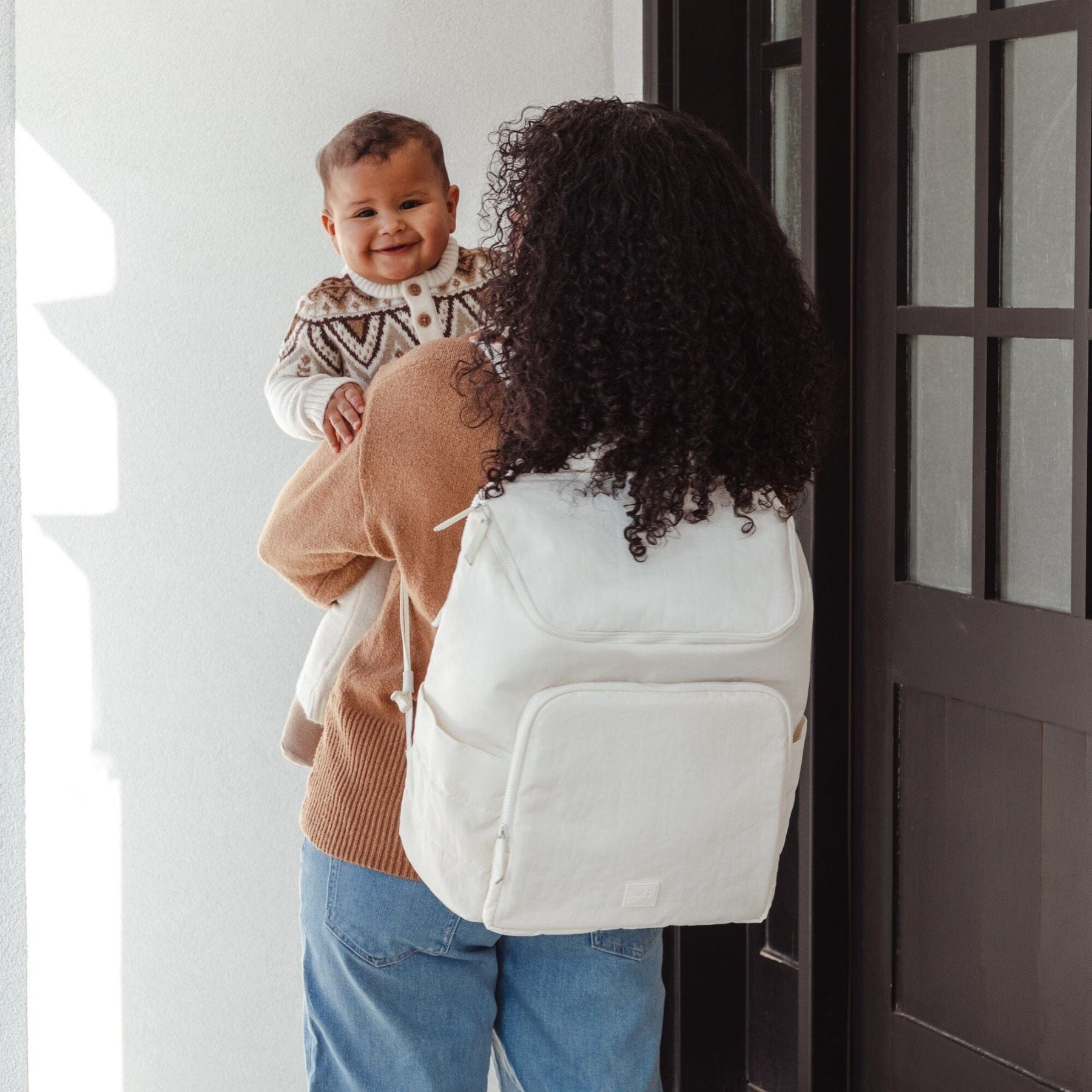 Woman with Polar Zurich Diaper Bag holding a child in a home setting