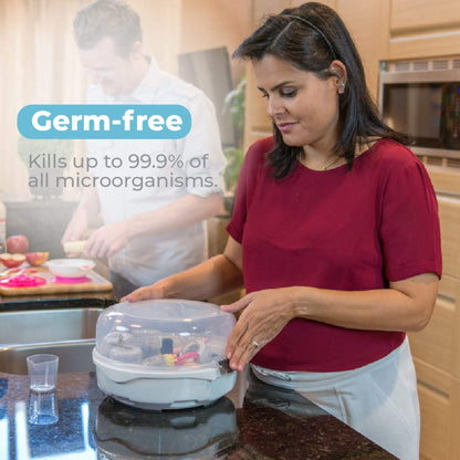 Woman holding Primo Passi Microwave Baby Bottle Sterilizer