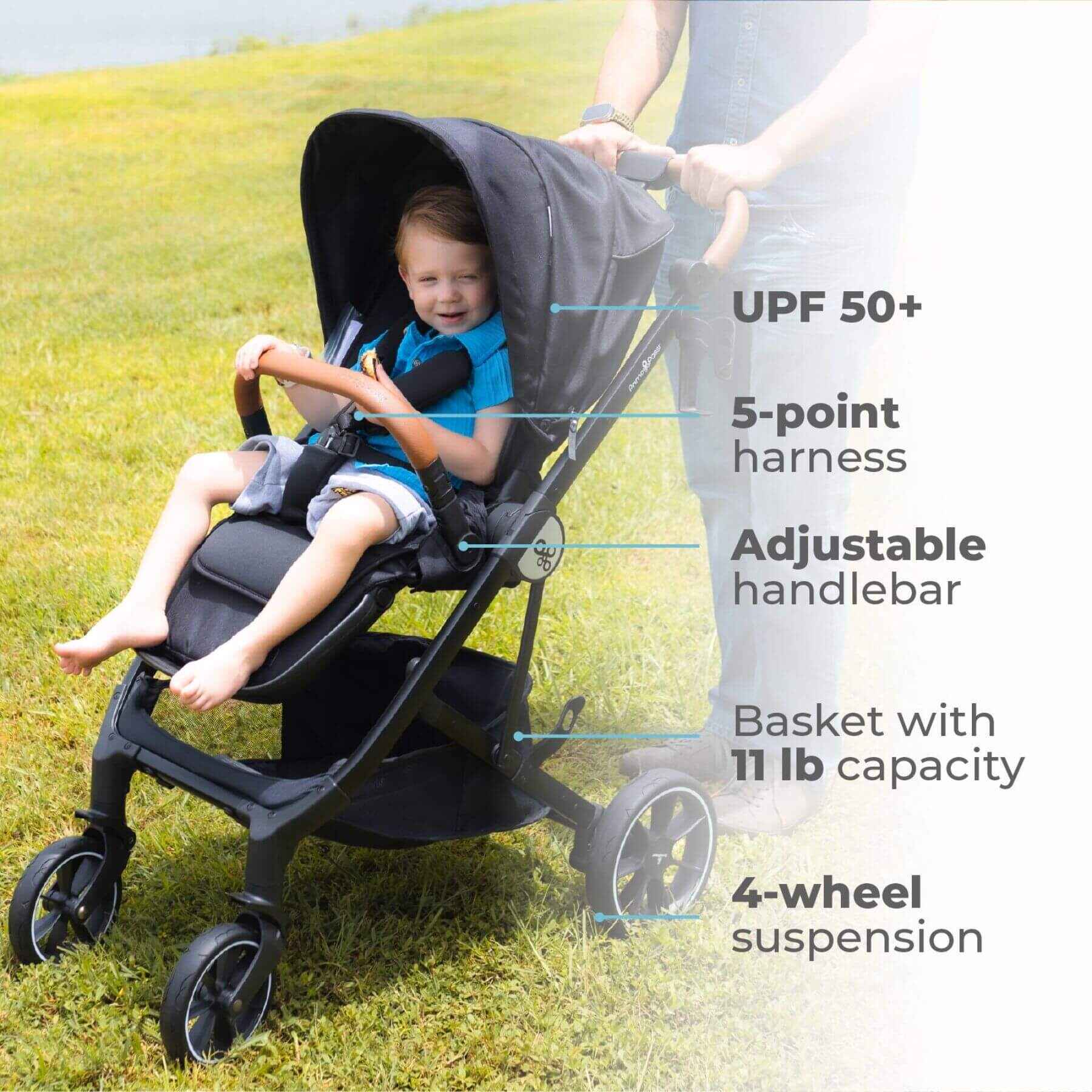 Child in Primo Passi Icon Baby Stroller V2 Grey with highlighted features on a grassy background