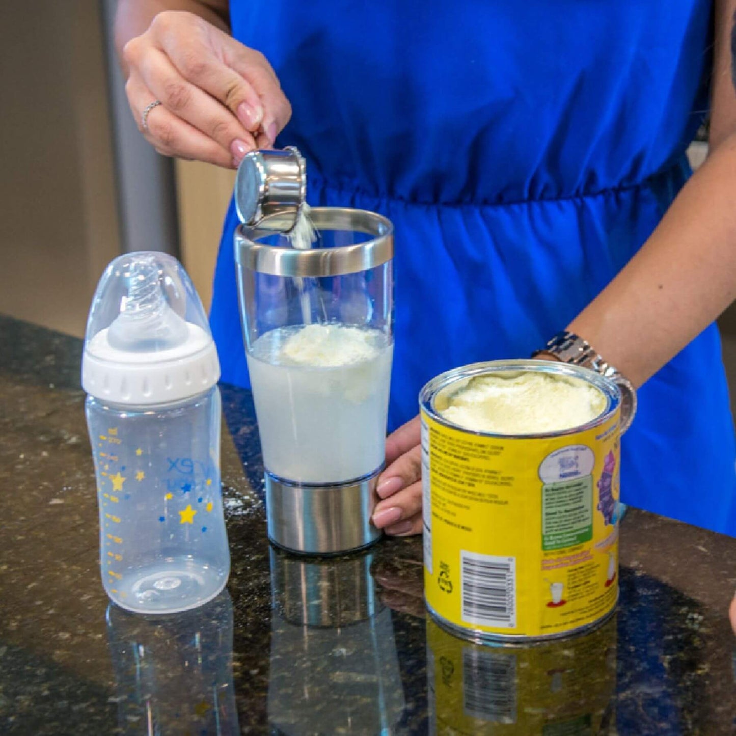 Person making formula with Primo Passi Portable Formula Mixer 