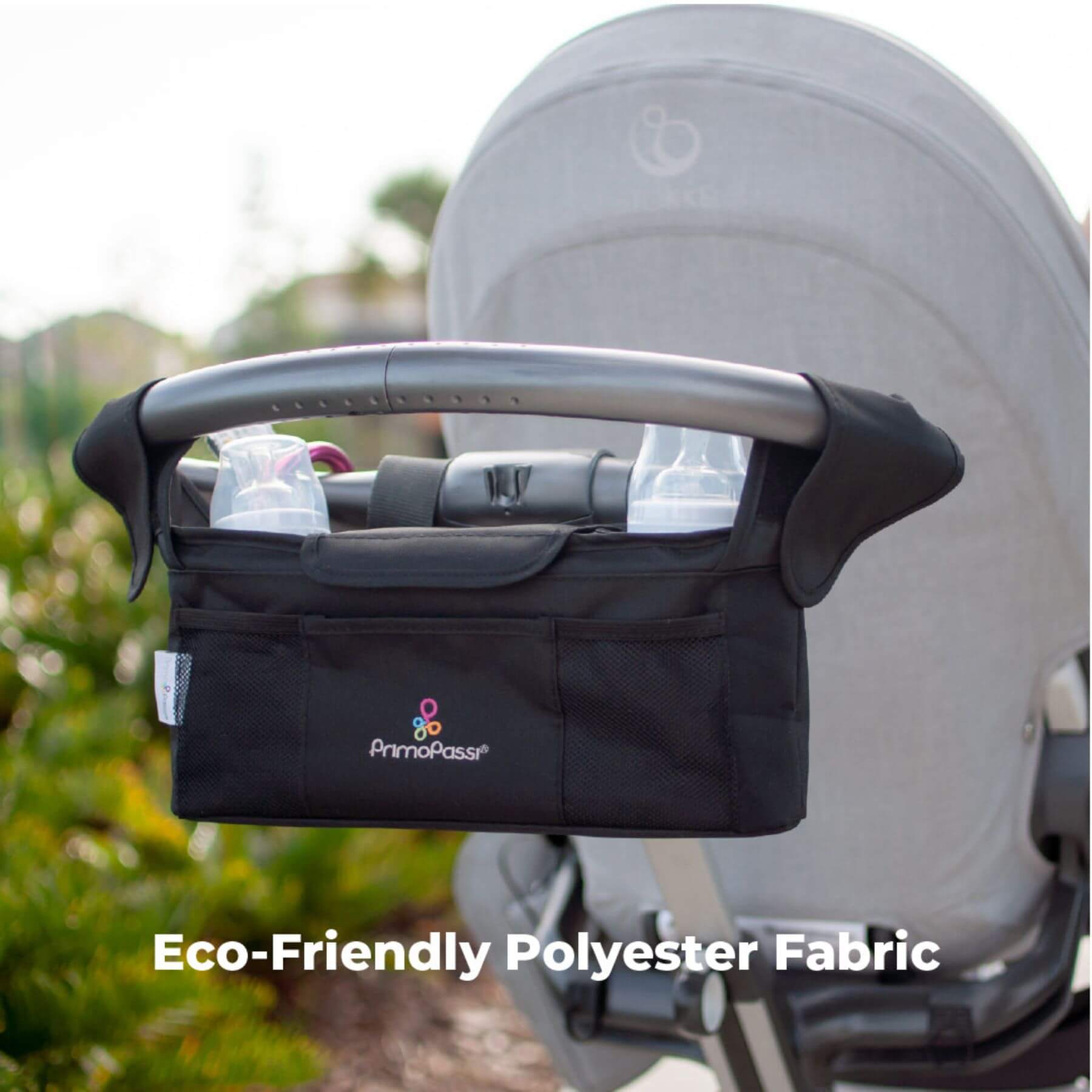 Primo Passi Stroller Handle Organizer attached to a stroller with text 'Eco-Friendly Polyester Fabric'.