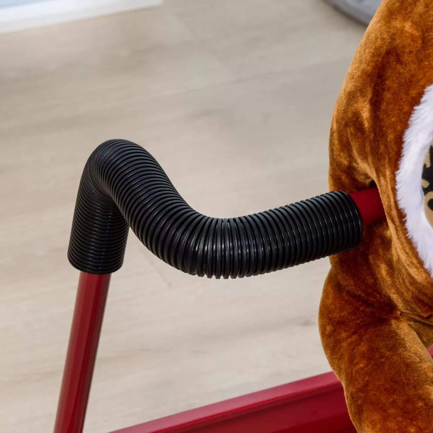 Close-up of Qaba Ride on Horse with Animal Sounds Brown on a light wooden floor.