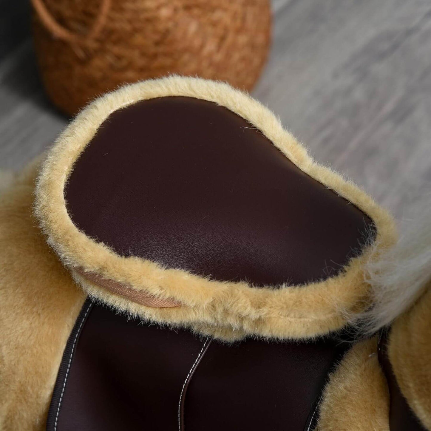 Close-up of Qaba Ride-on Walking Rolling Kids Horse Brown on a wooden floor.