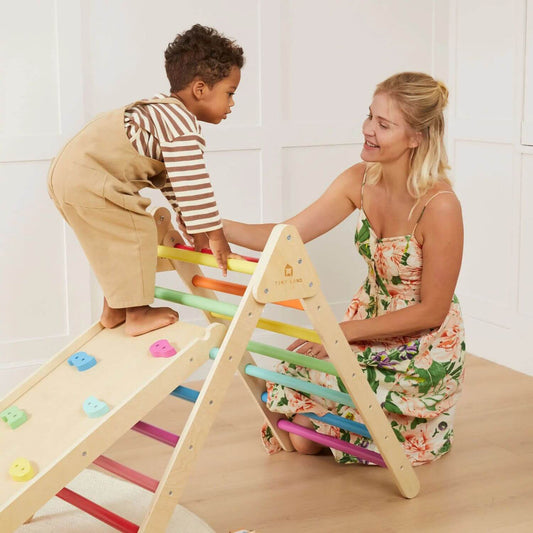 Mom Holding Baby Playing Tiny Land® 7-in-1 Rainbow Climbing Set