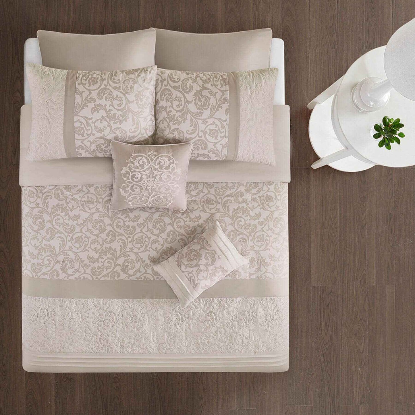 Ramsey Embroidered 8 Piece Comforter Set Neutral on a bed with a wooden headboard.