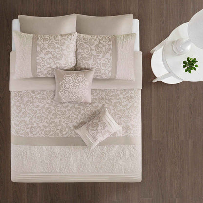 Ramsey Embroidered 8 Piece Comforter Set Neutral on a bed with a wooden headboard.