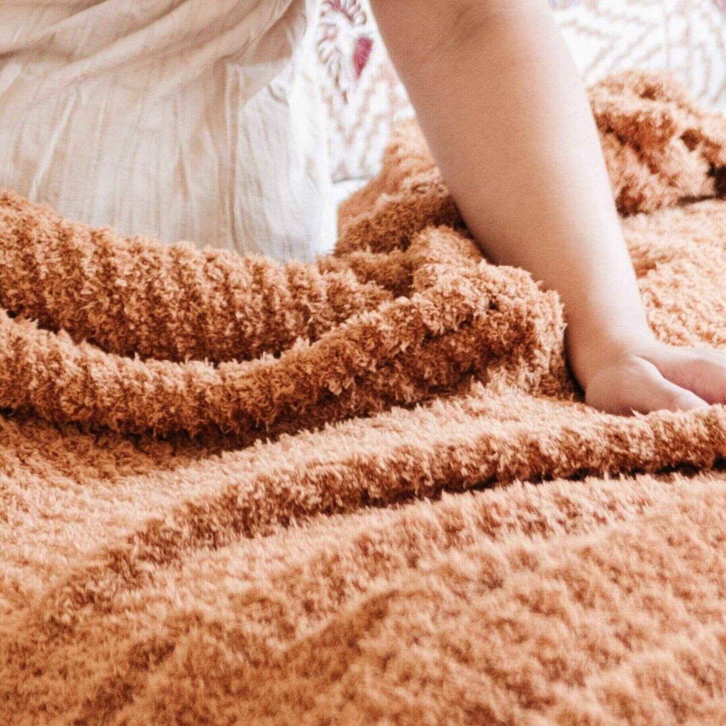 Close-up of Saranoni Ribbed Bamboni® XL Blanket - Gingerket with a blurred background