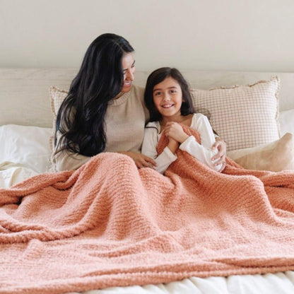 Woman and child under Saranoni Ribbed Bamboni® XL Blanket - Sun-Kissed on a bed