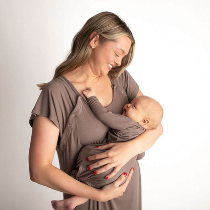 A woman wearing Three Little Tots Ribbed Cocoa Brown Mommy Gown holds and breastfeeds a baby wearing a matching long-sleeve sleep sack.