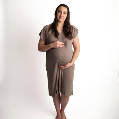 A pregnant woman wearing Three Little Tots Ribbed Cocoa Brown Mommy Gown, standing against a plain white studio background.