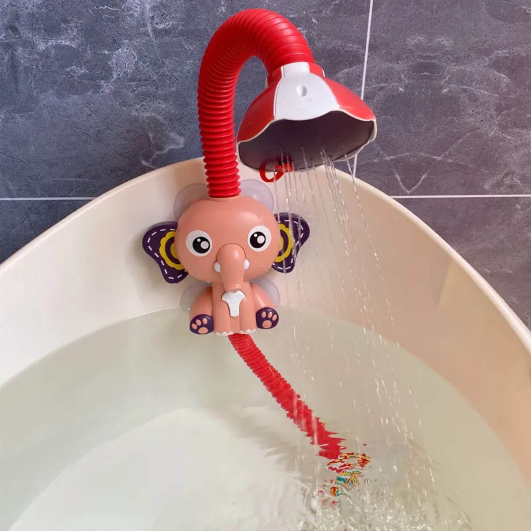 Baby shower head with elephant design in a bathtub