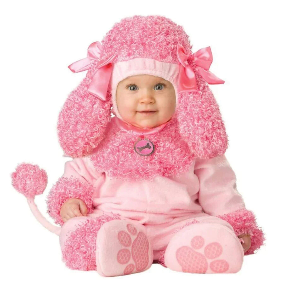 Baby in a pink poodle costume with a white background