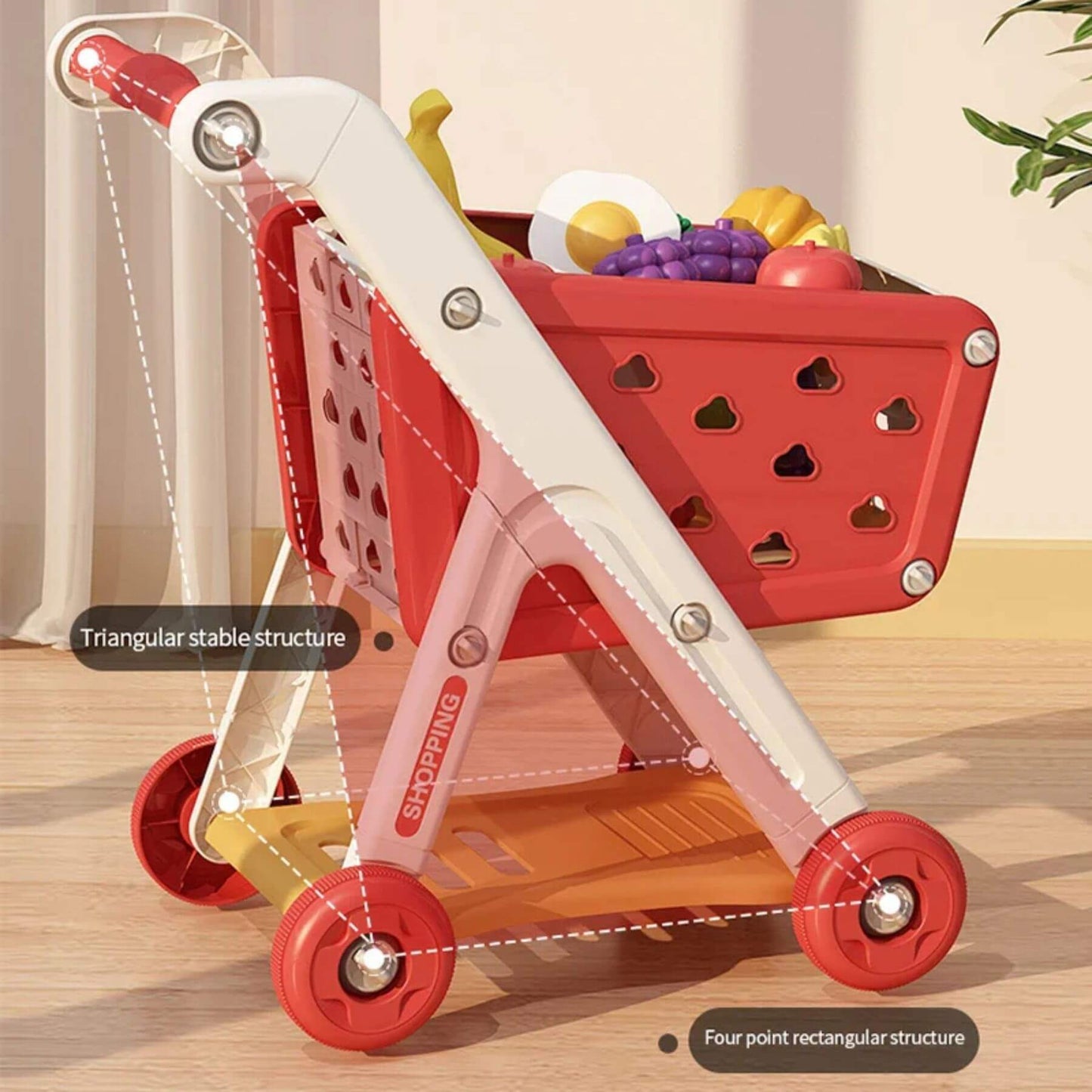 RocketBaby USA Shopping Cart Toy with a basket filled with fruits on a wooden floor.