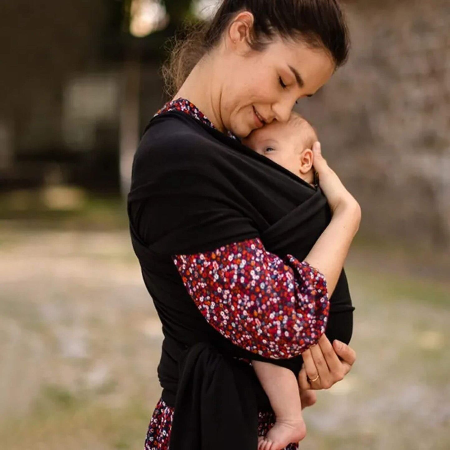 Woman holding a baby in RocketBaby USA Cotton Baby Wrap outdoors
