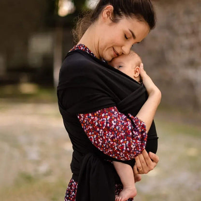 Woman holding a baby in RocketBaby USA Cotton Baby Wrap outdoors