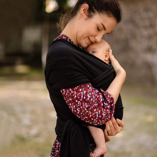 Woman holding a baby in RocketBaby USA Cotton Baby Wrap outdoors
