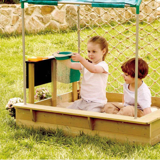 Two children playing in Hape Sandbox Cabana Kit on a grassy area.