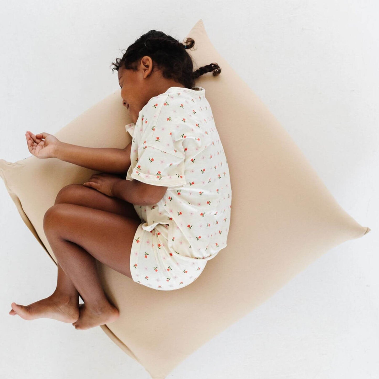 Child sleeping on Toki Kids Sandcastle Bean Bag