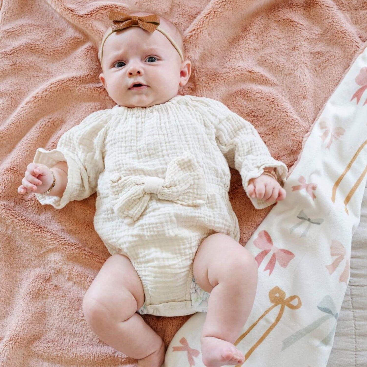 Baby sleeping on Saranoni Minky/Lush Receiving Blanket Bow