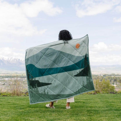 Person holding Saranoni Outdoor Blanket outdoors