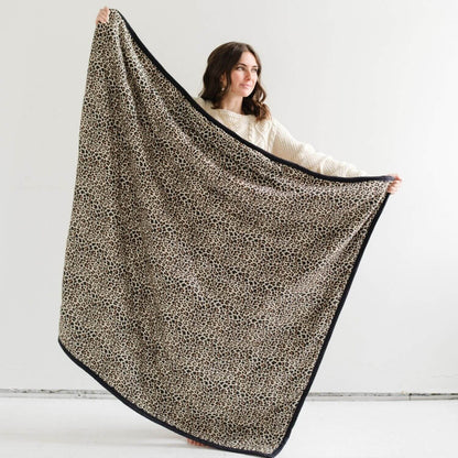 Person holding Saranoni Outdoor Blanket with a white background