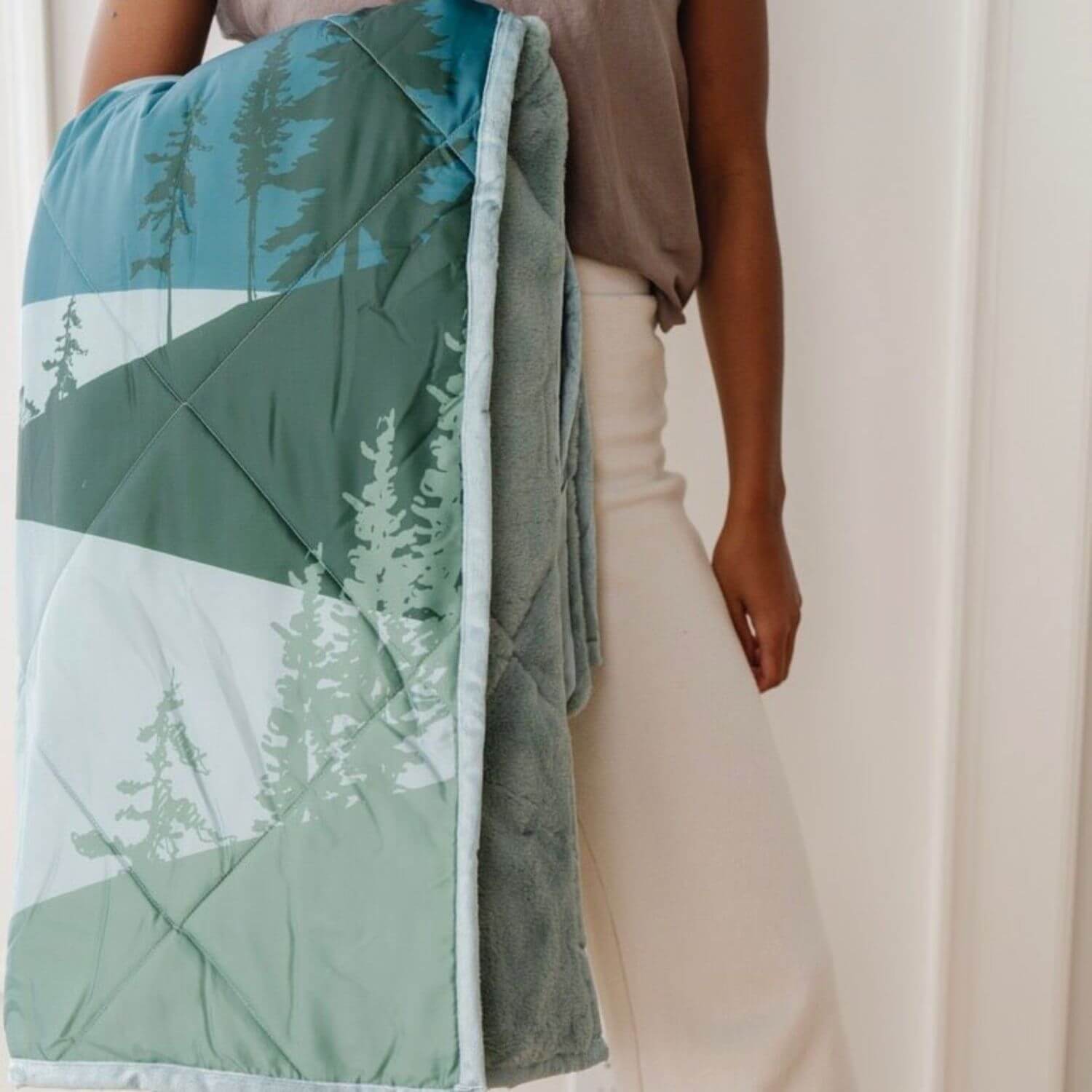Person holding Saranoni Outdoor Blanket against a neutral background