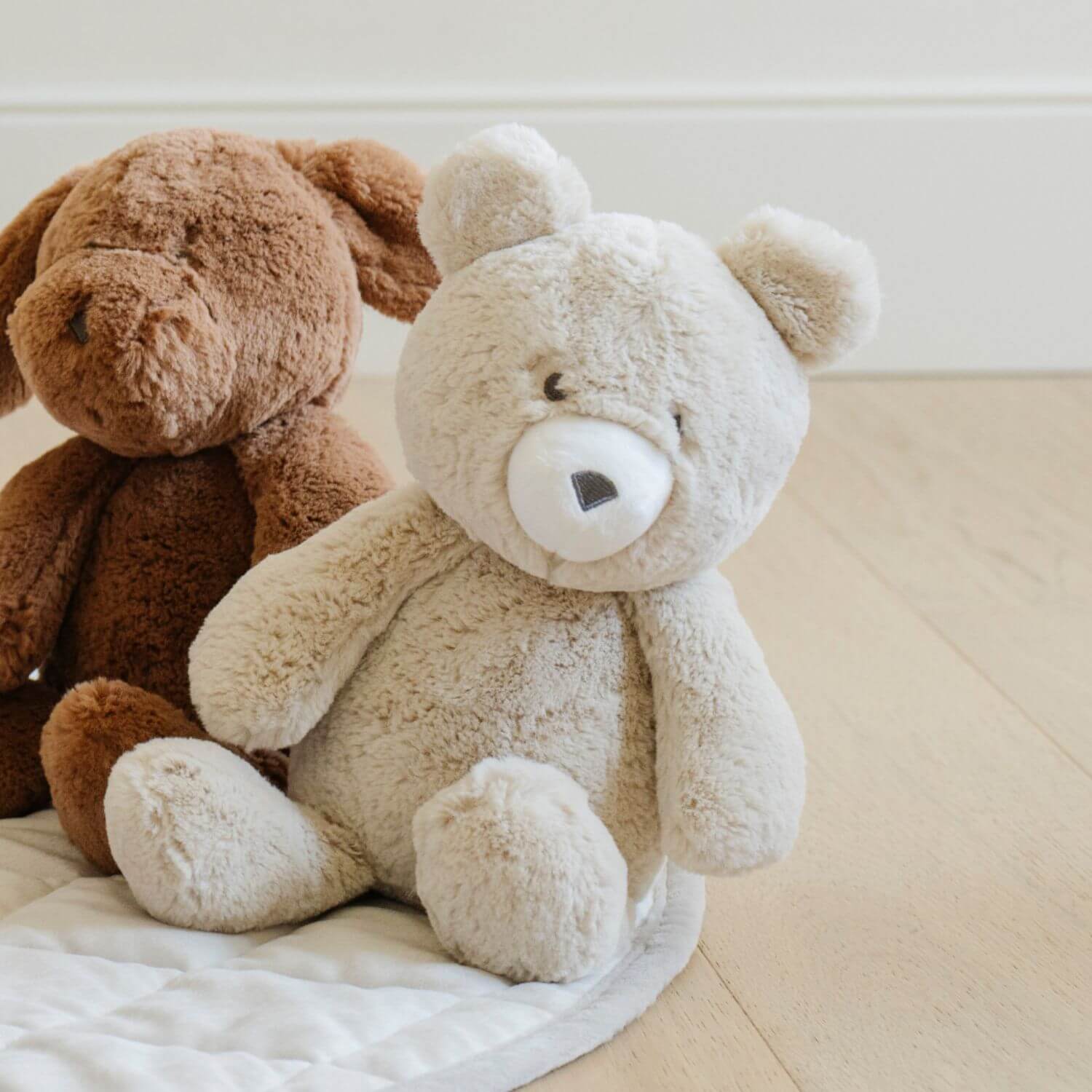 Two Saranoni Stuffed Animals, sitting on a light-colored surface.