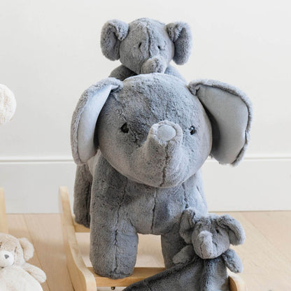 Two gray plush elephants stacked on top of each other with a white background