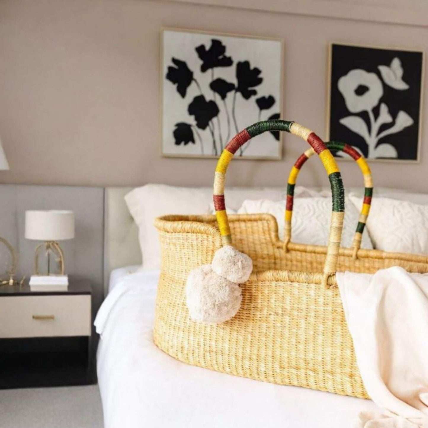 Plum+Sparrow Savannah African Moses Basket on a bed in a bedroom setting