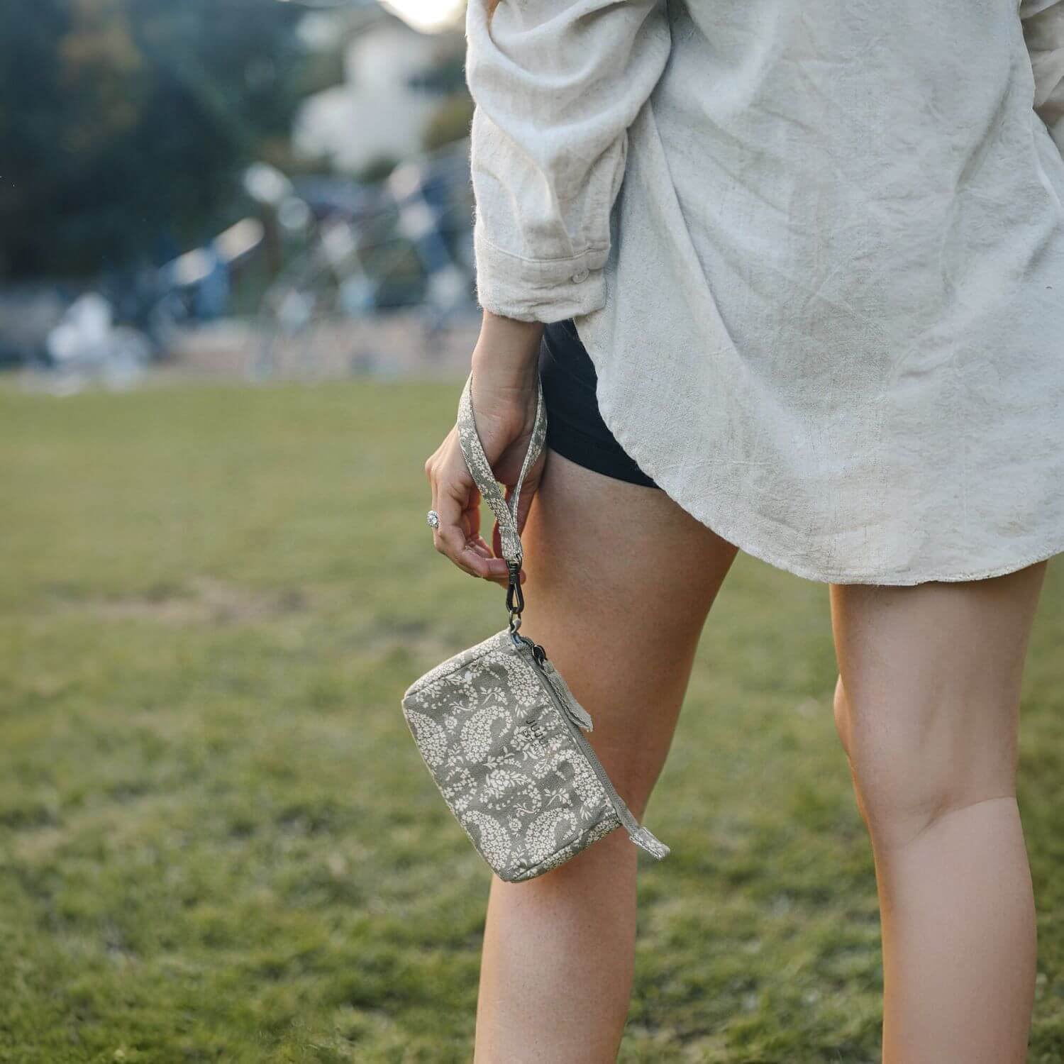 Woman Carrying Sazan + JuJuBe Pouch Clutch Purse - Paisley Floral