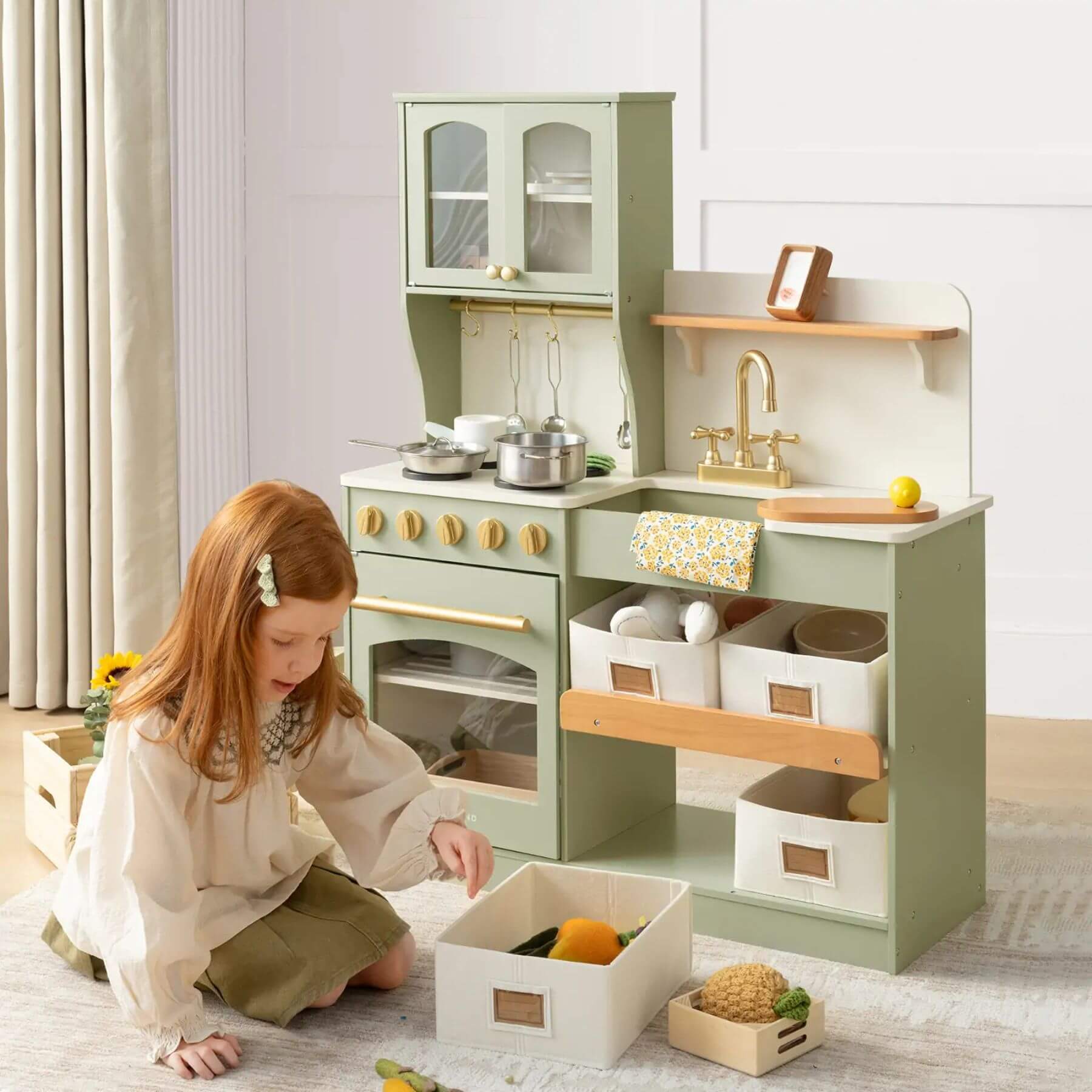 Child playing with Tiny Land® Serenity Play Kitchen Sage Green in a room.