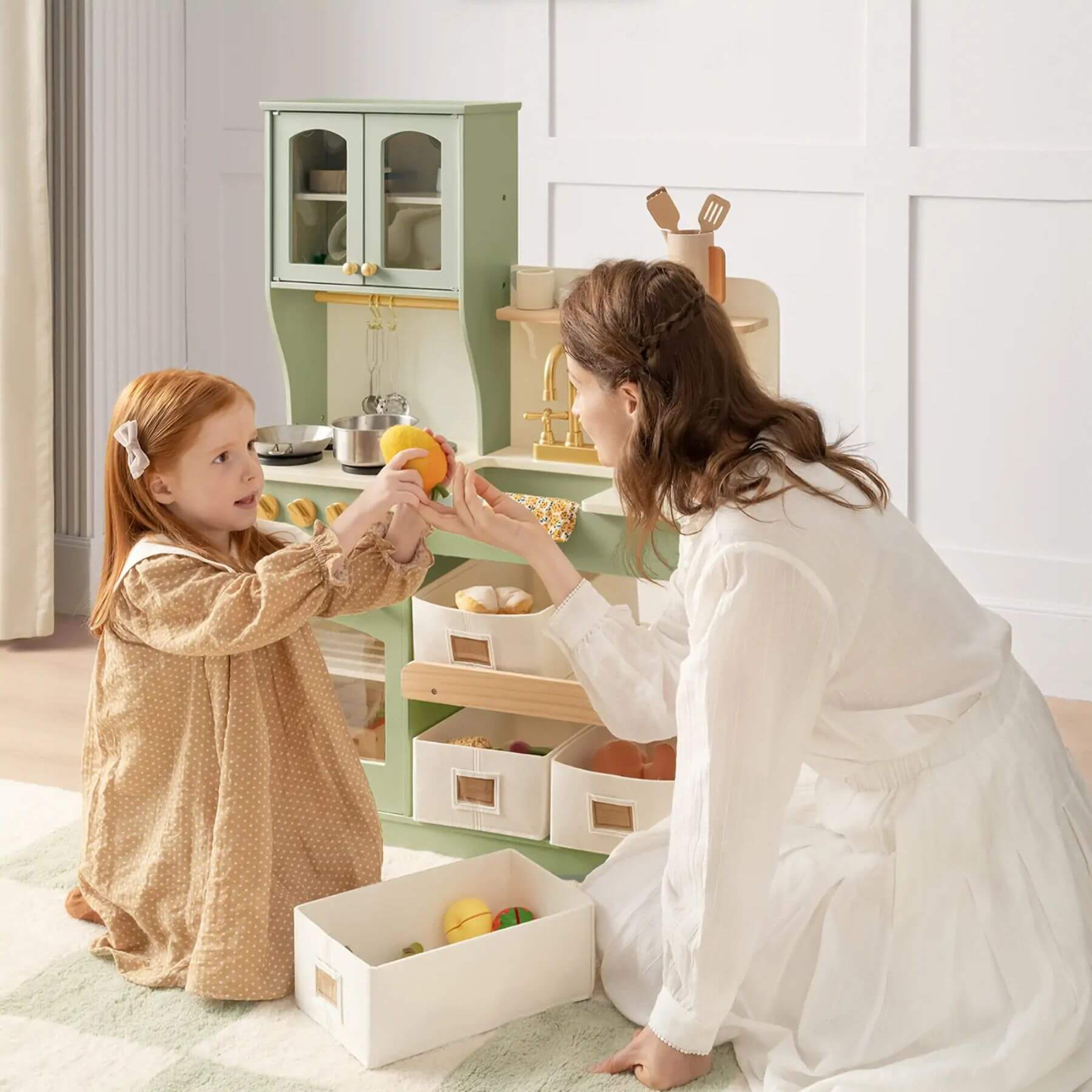Woman and child playing with Tiny Land® Serenity Play Kitchen Sage Green in a bright room.
