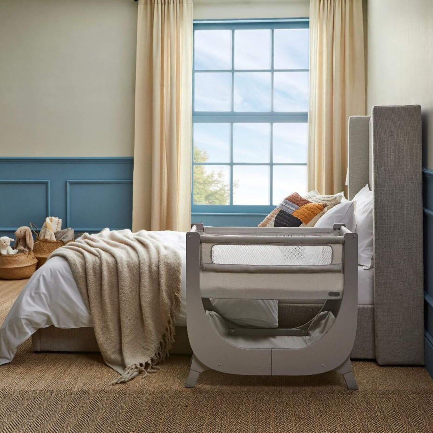 Baby crib in a bedroom with a window and curtains