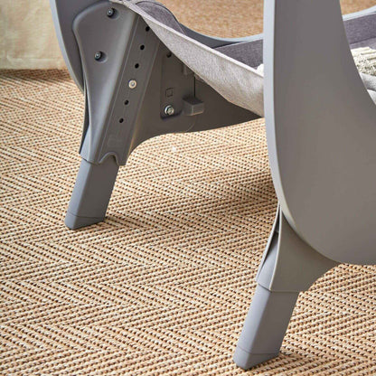 Shnuggle Air Lite Bedside Bassinet - Gray on a textured beige surface