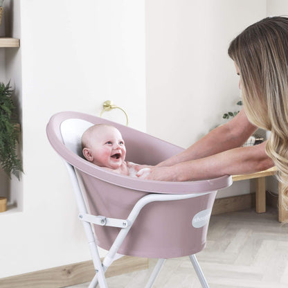 Baby in Shnuggle Bath with a woman in a home setting