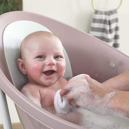 Baby being bathed in Shnuggle Bath with soapy water
