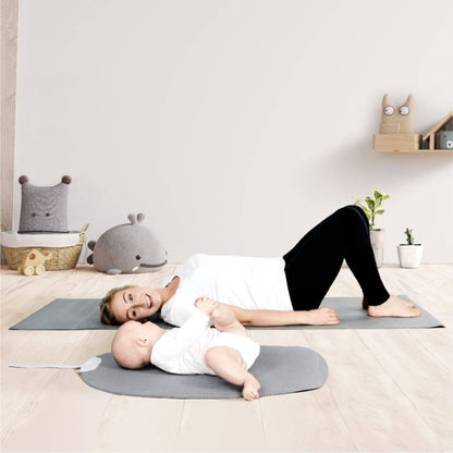 Baby lying on Shnuggle Portable Changing & Play Mat - Gray with mom next to him
